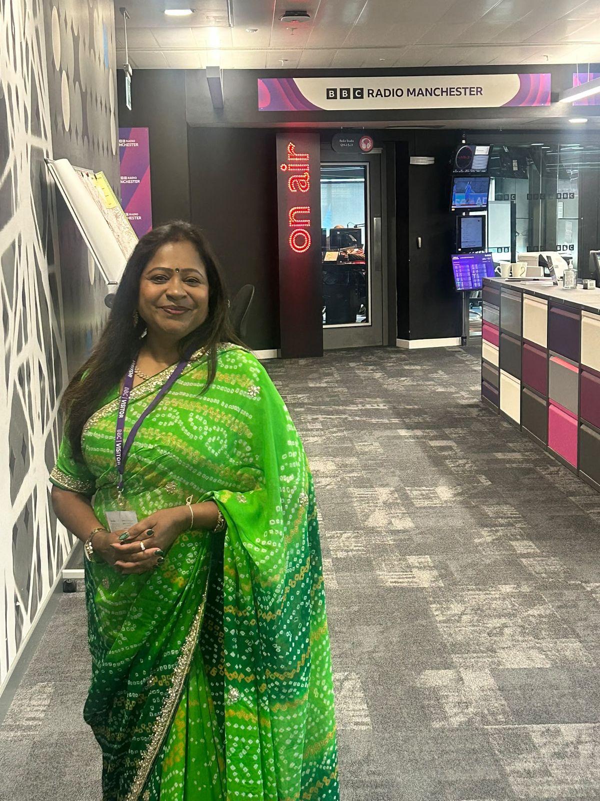 Bhavana Ghosh in the BBC Radio Manchester newsroom beside the On Air sign