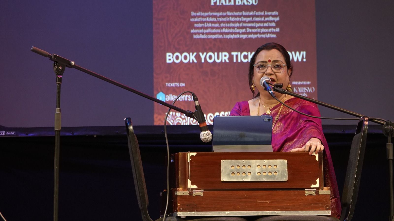 Mrs Piali Basu Ray Choudhury singing with a harmonium at the Manchester Boishakh Festival